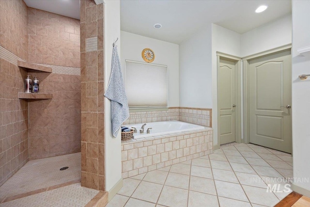 bathroom with tile patterned floors and separate shower and tub