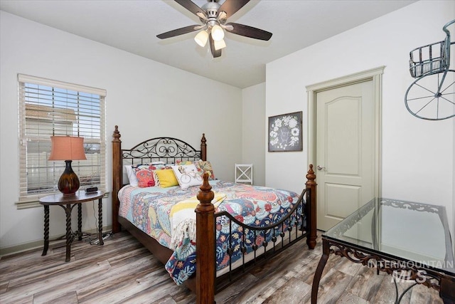 bedroom with ceiling fan and wood-type flooring