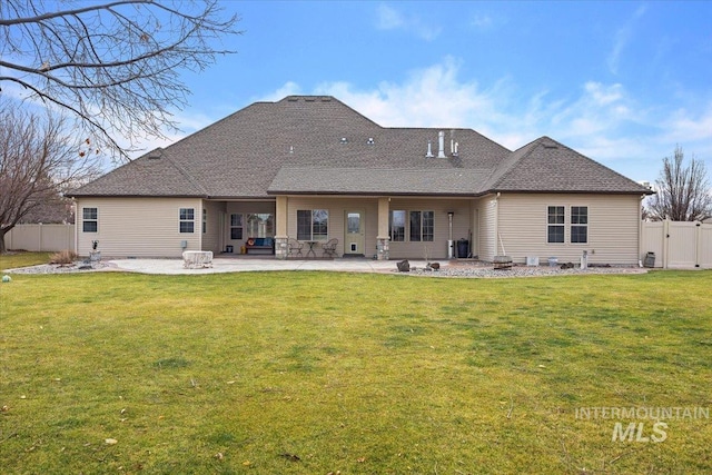 back of house featuring an outdoor fire pit, a yard, and a patio