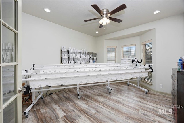 interior space with wood-type flooring and ceiling fan