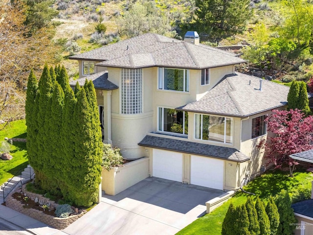 677 W Sandstone Ct, Boise, ID 83702 - view of front of property with stucco siding, a garage, concrete driveway, and a shingled roof