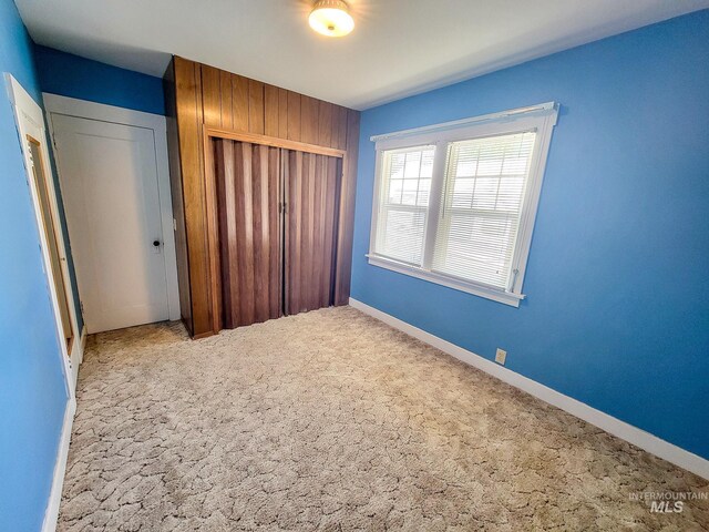 unfurnished bedroom featuring a closet and carpet flooring