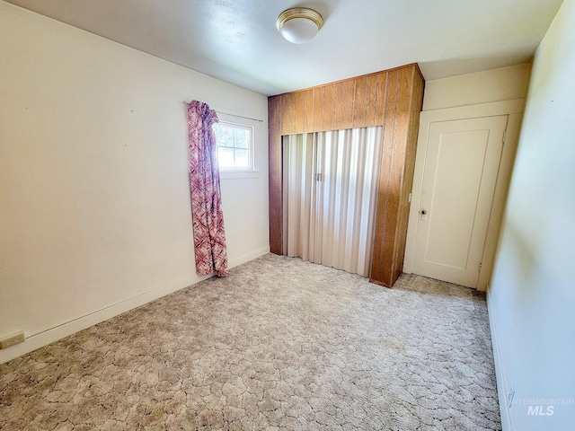 unfurnished bedroom featuring light carpet