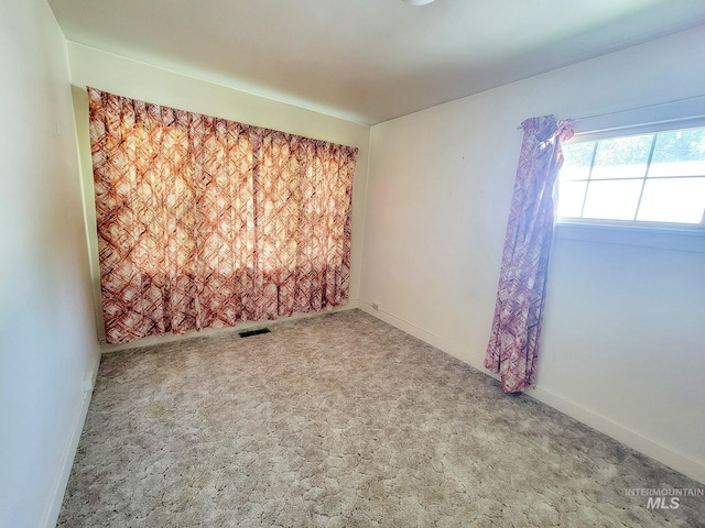 unfurnished room featuring carpet