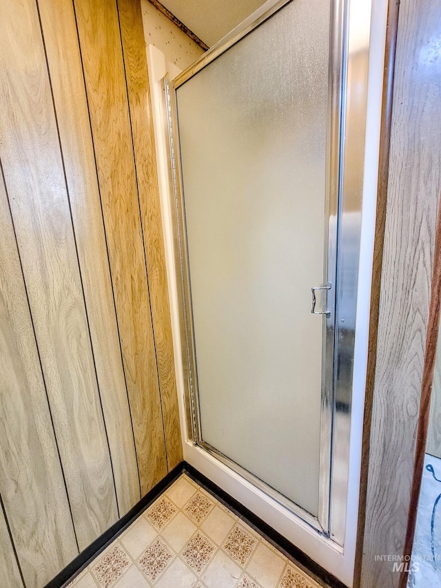 bathroom featuring walk in shower and tile patterned flooring