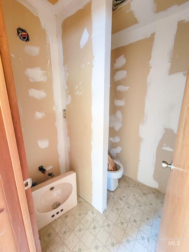 bathroom featuring toilet and tile patterned flooring