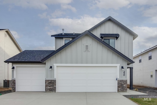 view of front of home with stone siding, board and batten siding, and roof with shingles
