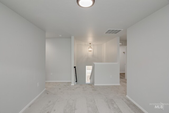 carpeted empty room with baseboards and visible vents