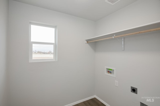 washroom with hookup for an electric dryer, washer hookup, baseboards, dark wood-style flooring, and laundry area