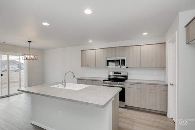 kitchen with light brown cabinets, appliances with stainless steel finishes, and light countertops