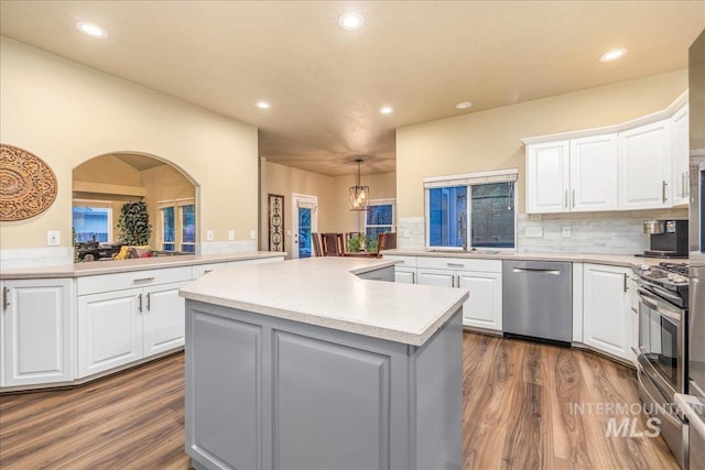 kitchen with appliances with stainless steel finishes, white cabinetry, and sink