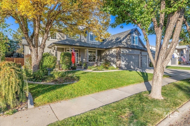 view of front of house with a front yard, a porch, and a garage