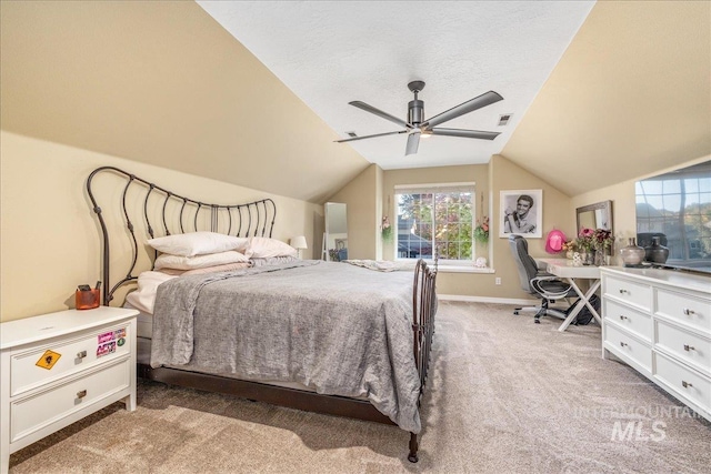 bedroom with a textured ceiling, ceiling fan, light carpet, and vaulted ceiling