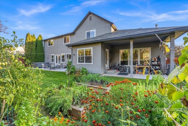 rear view of property featuring a patio area and a lawn