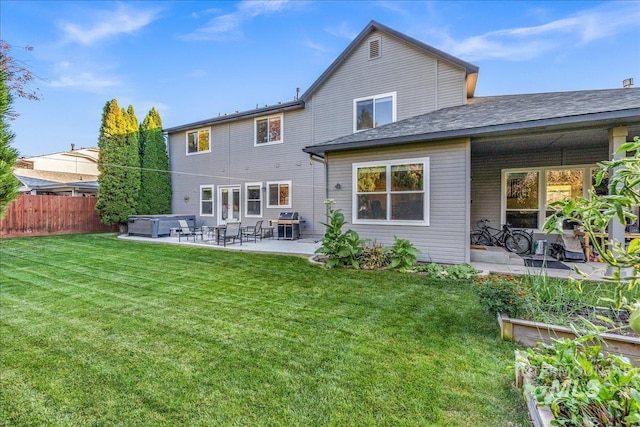 rear view of house with a yard and a patio