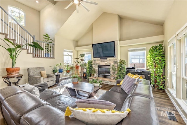 living room with a fireplace, ceiling fan, hardwood / wood-style floors, and plenty of natural light