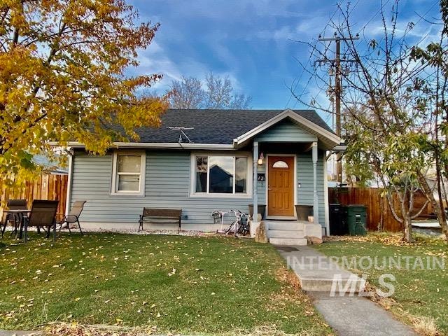 bungalow-style home with a front yard