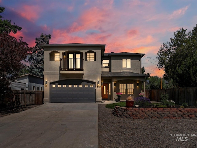 2510 N 24th St, Boise, ID 83702 - view of front of home featuring a balcony, concrete driveway, french doors, an attached garage, and stucco siding