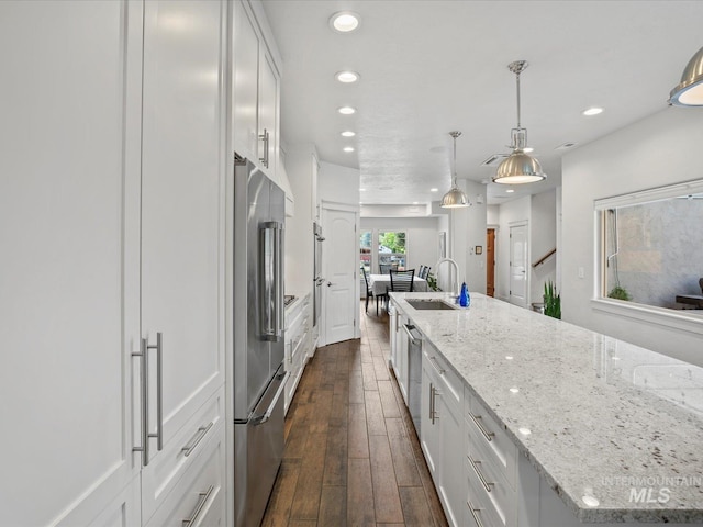 2510 N 24th St, Boise, ID 83702 - kitchen featuring stainless steel appliances, white cabinets, recessed lighting, dark wood finished floors, and light stone countertops