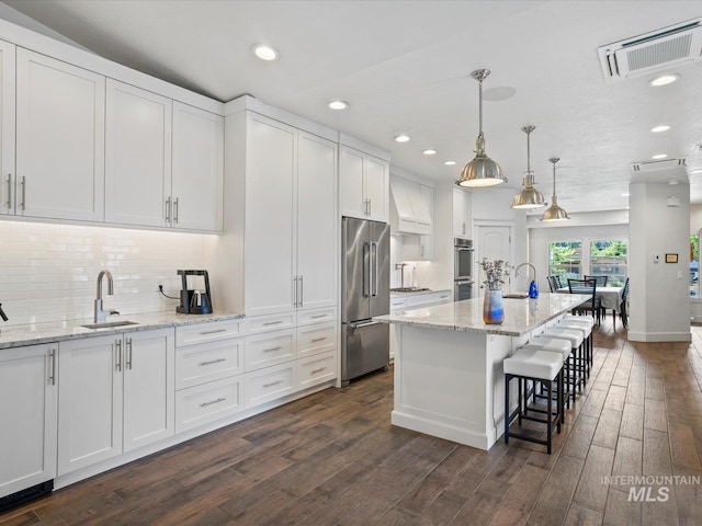 2510 N 24th St, Boise, ID 83702 - kitchen with appliances with stainless steel finishes, white cabinets, dark wood-style flooring, recessed lighting, and backsplash