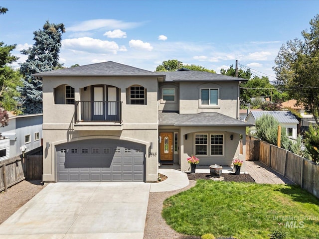 2510 N 24th St, Boise, ID 83702 - view of front of home with a balcony, a garage, stucco siding, and driveway