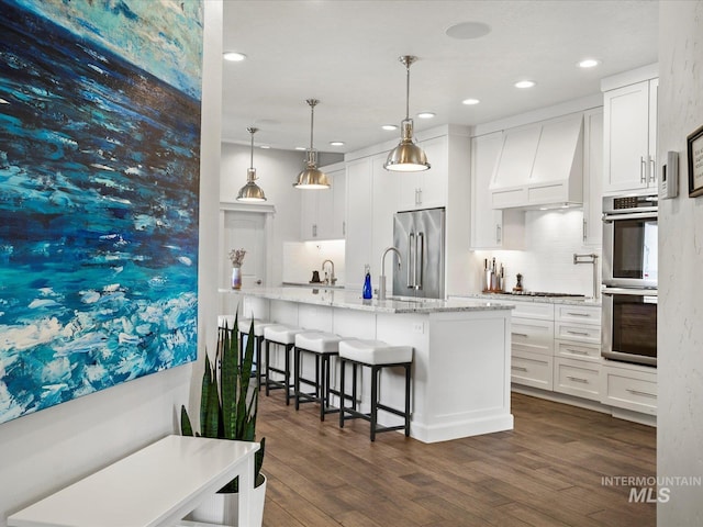 2510 N 24th St, Boise, ID 83702 - kitchen featuring custom range hood, stainless steel appliances, white cabinetry, dark wood finished floors, and recessed lighting