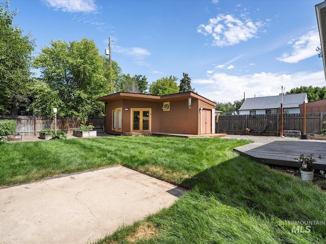 2510 N 24th St, Boise, ID 83702 - rear view of property featuring a deck, a fenced backyard, french doors, and an outdoor structure