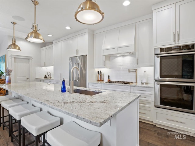 2510 N 24th St, Boise, ID 83702 - kitchen featuring appliances with stainless steel finishes, dark wood-type flooring, recessed lighting, white cabinets, and tasteful backsplash