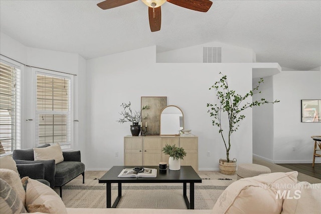 5692 S Flax Pl, Boise, ID 83716 - living room featuring ceiling fan, baseboards, a textured ceiling, lofted ceiling, and plenty of natural light