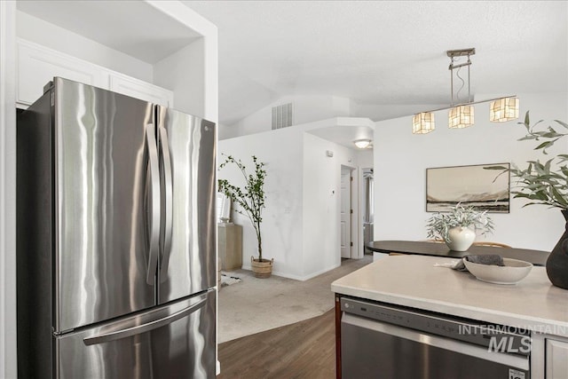 5692 S Flax Pl, Boise, ID 83716 - kitchen featuring appliances with stainless steel finishes, light countertops, vaulted ceiling, white cabinets, and dark wood-style flooring