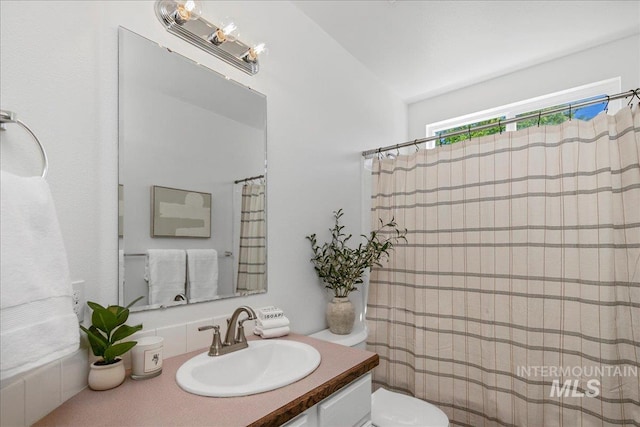 5692 S Flax Pl, Boise, ID 83716 - bathroom featuring vanity, toilet, vaulted ceiling, and a shower with shower curtain