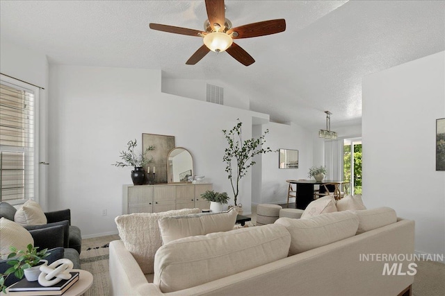 5692 S Flax Pl, Boise, ID 83716 - living room featuring carpet flooring, a ceiling fan, lofted ceiling, baseboards, and a textured ceiling