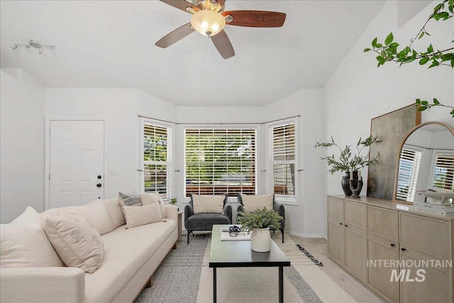 5692 S Flax Pl, Boise, ID 83716 - living area featuring a ceiling fan, light carpet, and baseboards