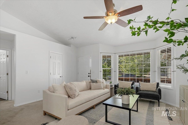 5692 S Flax Pl, Boise, ID 83716 - living area with a textured ceiling, light colored carpet, lofted ceiling, a ceiling fan, and baseboards