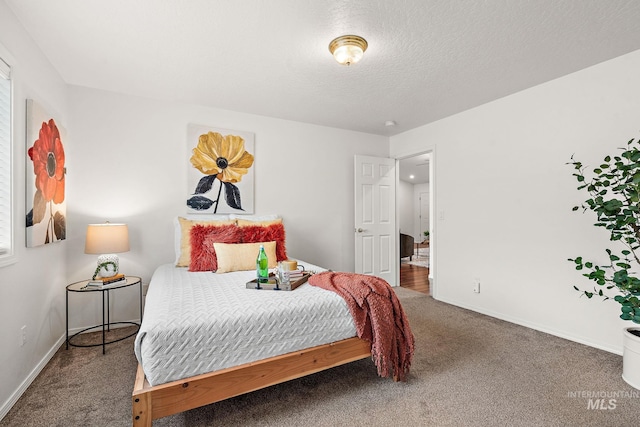 carpeted bedroom featuring a textured ceiling