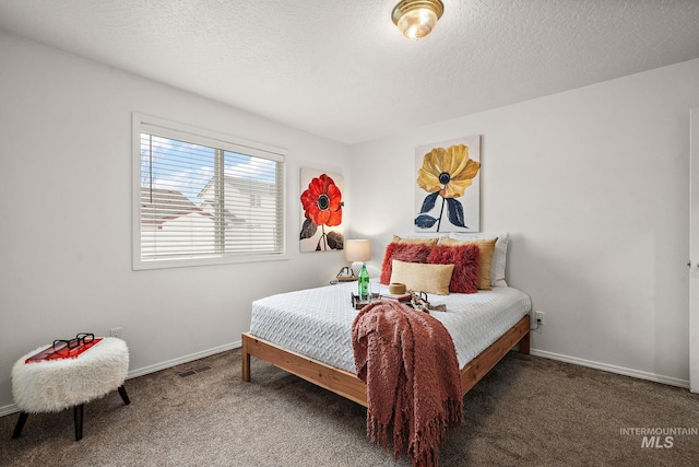 carpeted bedroom featuring a textured ceiling