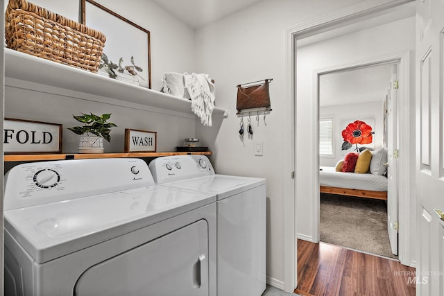 washroom featuring dark hardwood / wood-style flooring and washer and dryer