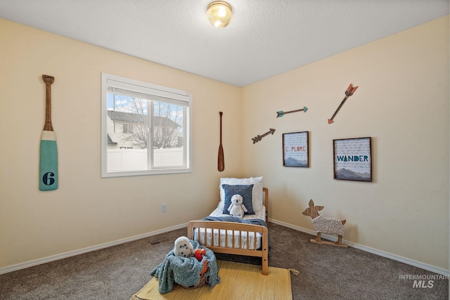 carpeted bedroom featuring a textured ceiling