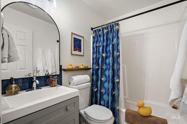 full bathroom featuring shower / bath combo, vanity, a textured ceiling, and toilet