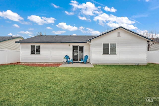 rear view of house featuring a yard and a patio area