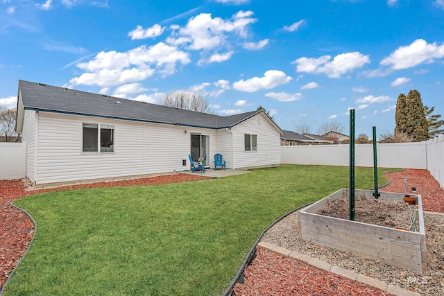 back of house with a lawn