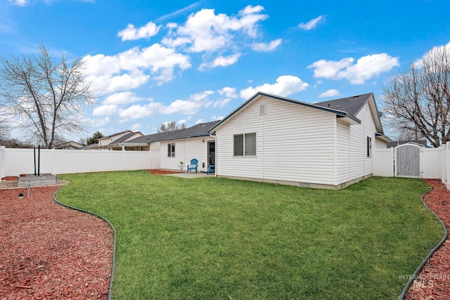 rear view of house featuring a yard and a patio area