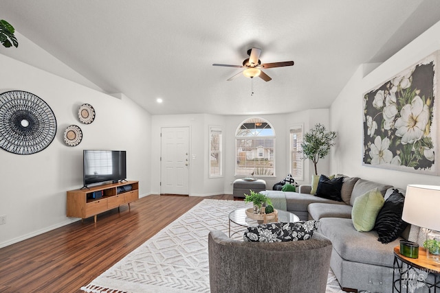 living room with lofted ceiling, dark wood-type flooring, and ceiling fan