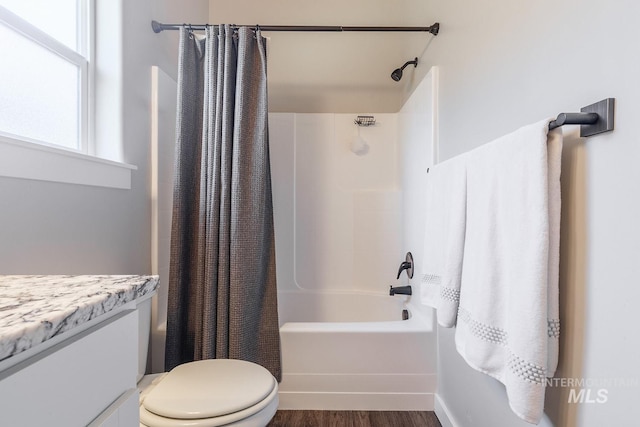 full bathroom featuring vanity, toilet, shower / bathtub combination with curtain, and hardwood / wood-style flooring