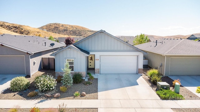 ranch-style home with a garage and a mountain view