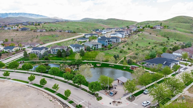 bird's eye view with a water and mountain view