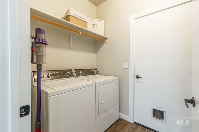 washroom with washer and clothes dryer and dark hardwood / wood-style flooring