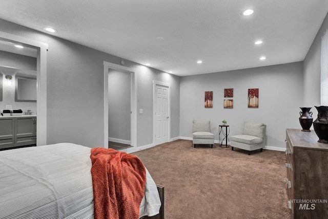 bedroom featuring ensuite bathroom and carpet