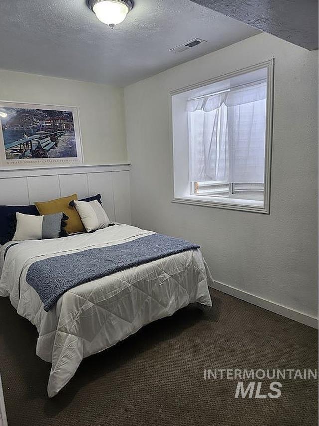 297 N 4228 E, Rigby, ID 83442 - carpeted bedroom with a textured ceiling
