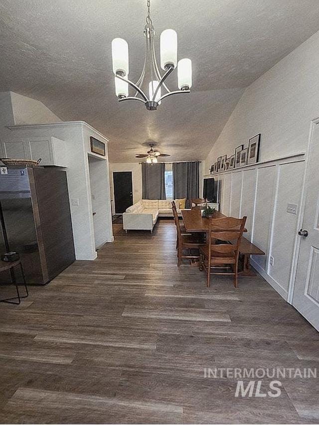 297 N 4228 E, Rigby, ID 83442 - dining area featuring a chandelier, dark wood finished floors, a textured ceiling, lofted ceiling, and a ceiling fan